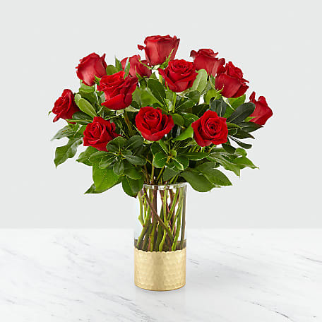 An elegant collection of deep red roses set in a clear glass
