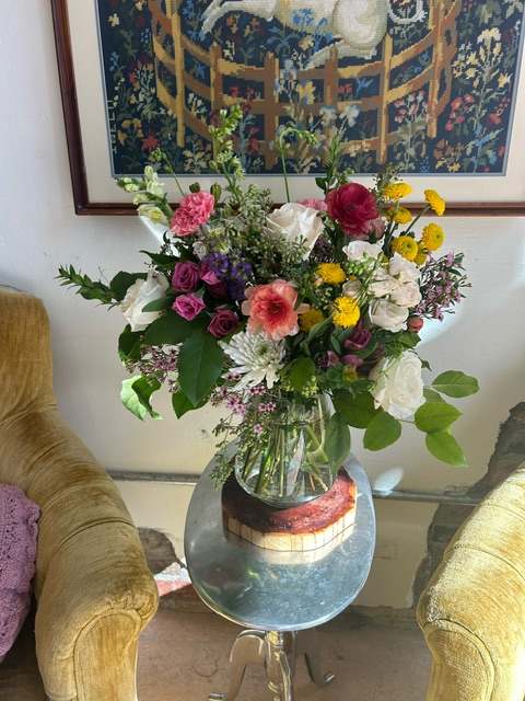 Farm fresh flowers in glass vase giving that just picked vibe. Product