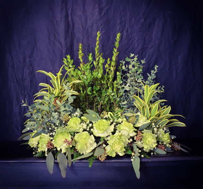 This stunning arrangement to surround an urn offers a mix of greens