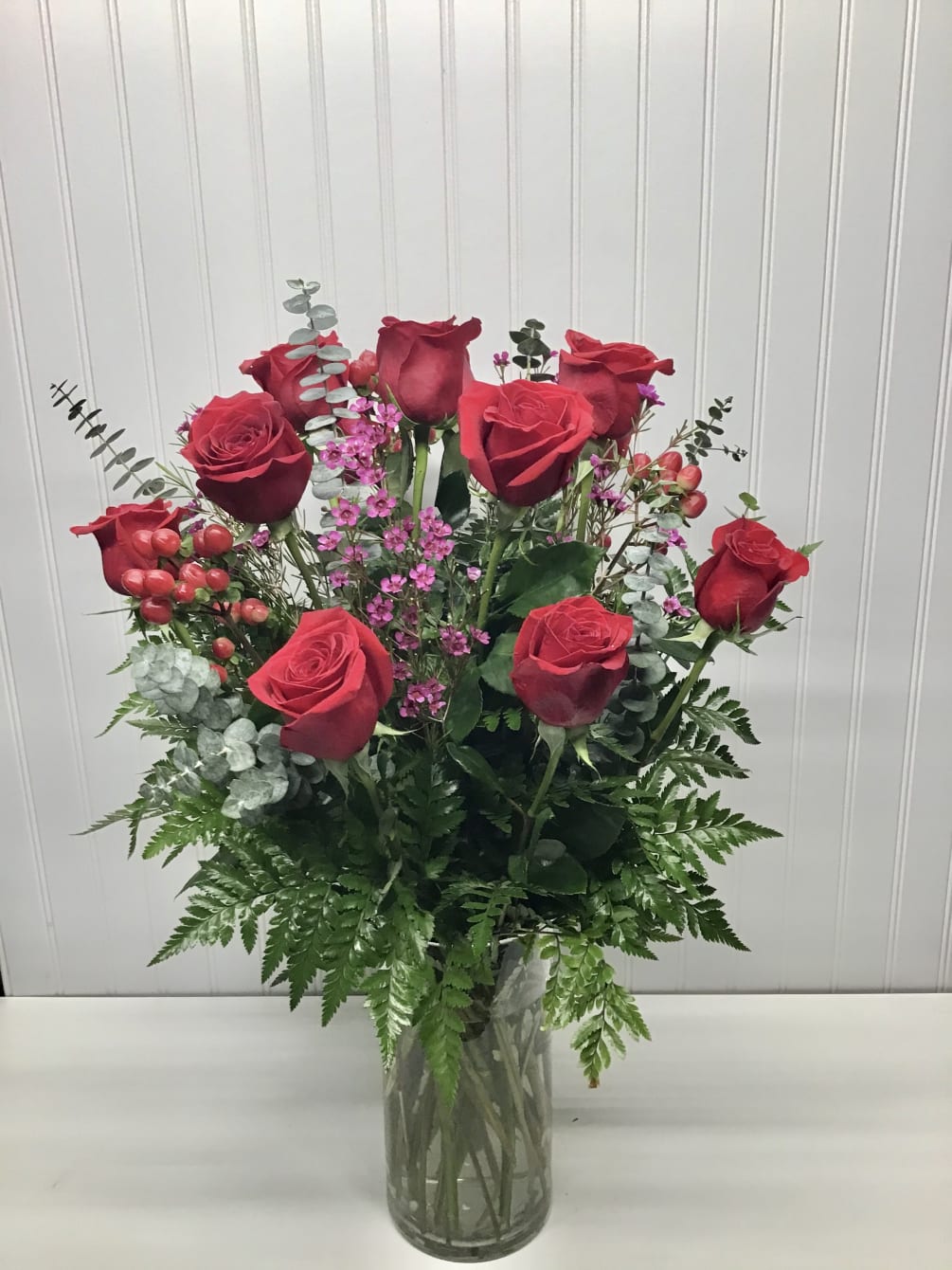 Classic dozen red roses with wax flower, blupurom and iucalipto