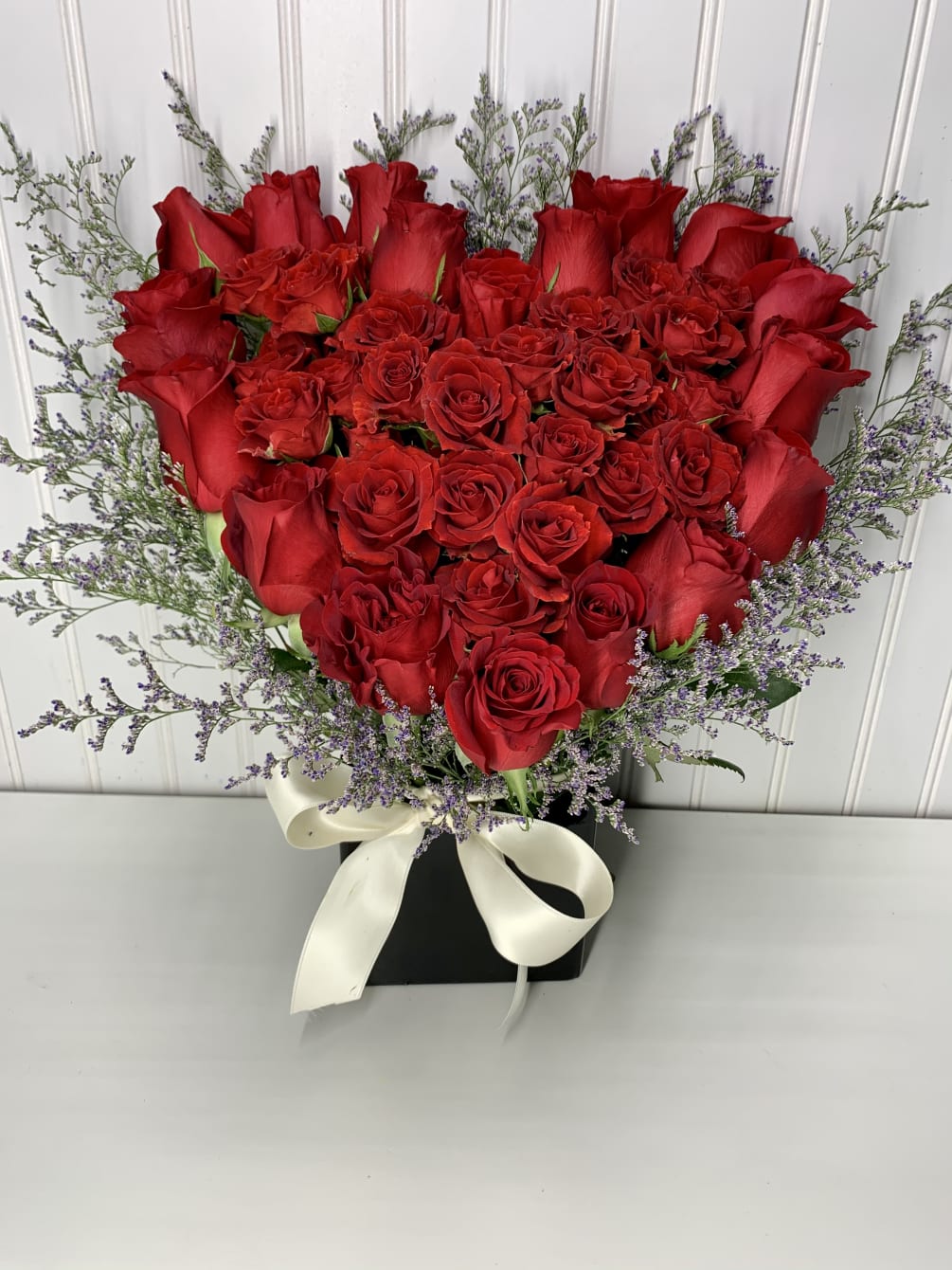 A lovely heart arrangement with roses  and cymbidium orchids