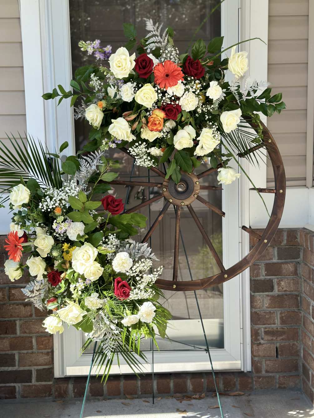 Using a wooden wheel as a base for a floral arrangement for