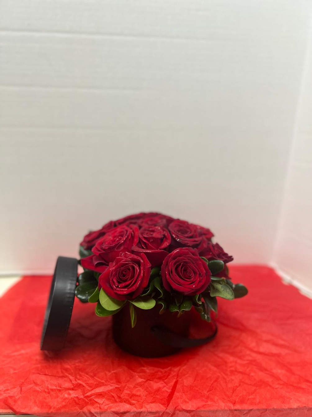 A new popular modern take on the traditional red rose arrangement. Designed