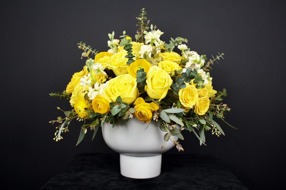 Traditional and contemporary rose flower arrangement designed in a ceramic round white