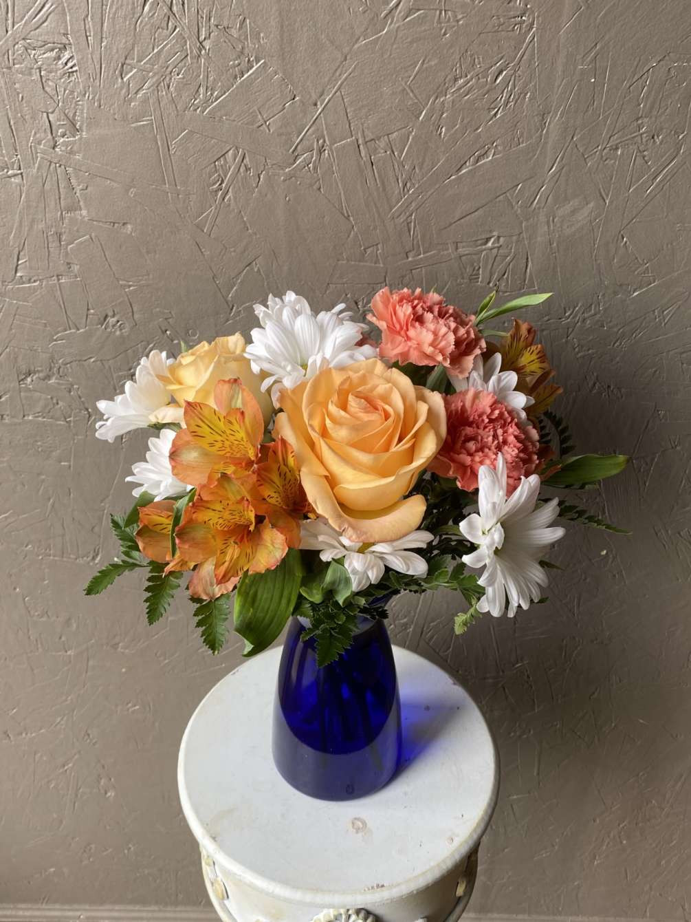 A beautiful combination of orange, peach, yellow, and white mixed florals fill