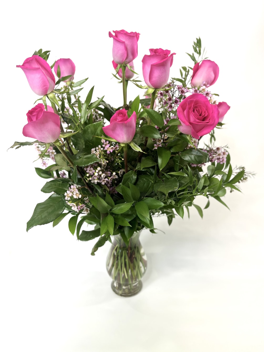  These beautiful hot pink roses are complemented with wax flower.