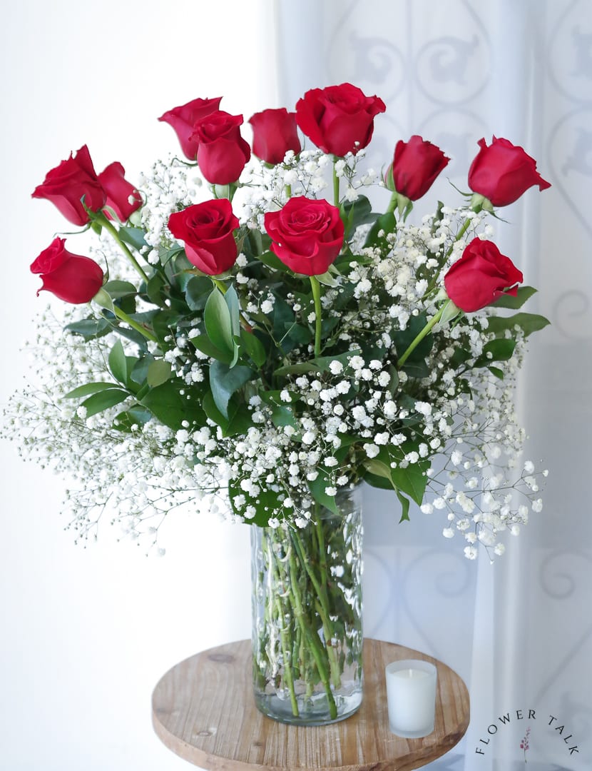 12 long stemmed red roses beautifully arranged with baby&#039;s breath. 
One of