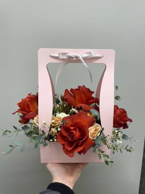 Orange pallet flowers in a pink box. (Ask us for available custom
