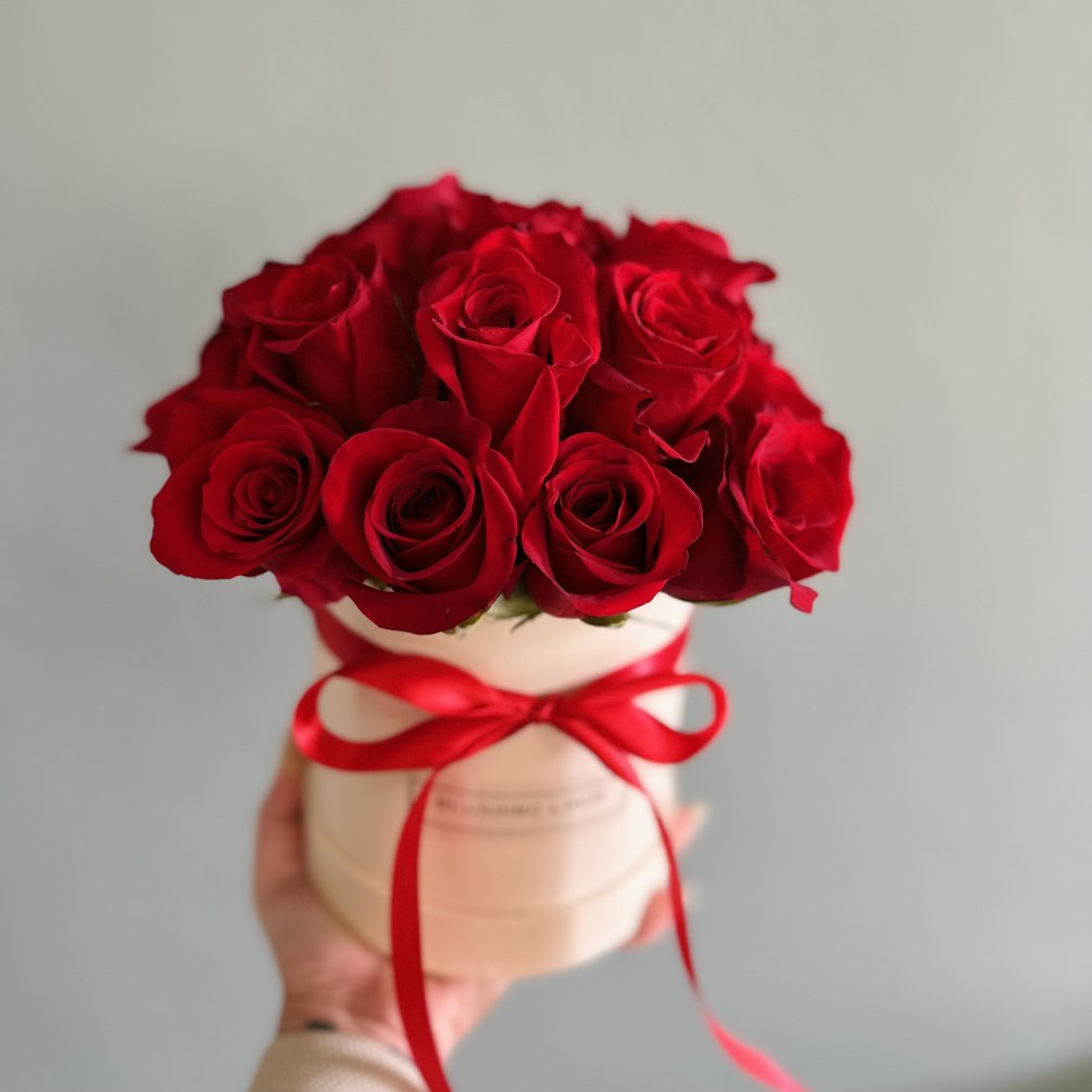 Premium red roses arranged in a hat box.