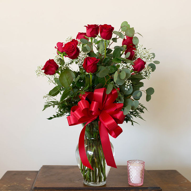 This beautiful classic arrangement of a dozen red roses is our special