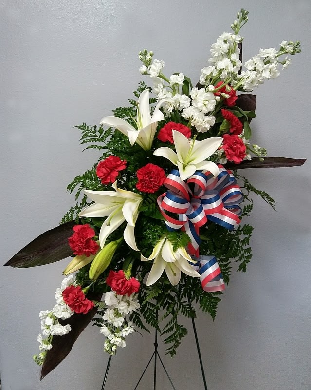 This standing spray is made with white stock, white oriental lilies, red
