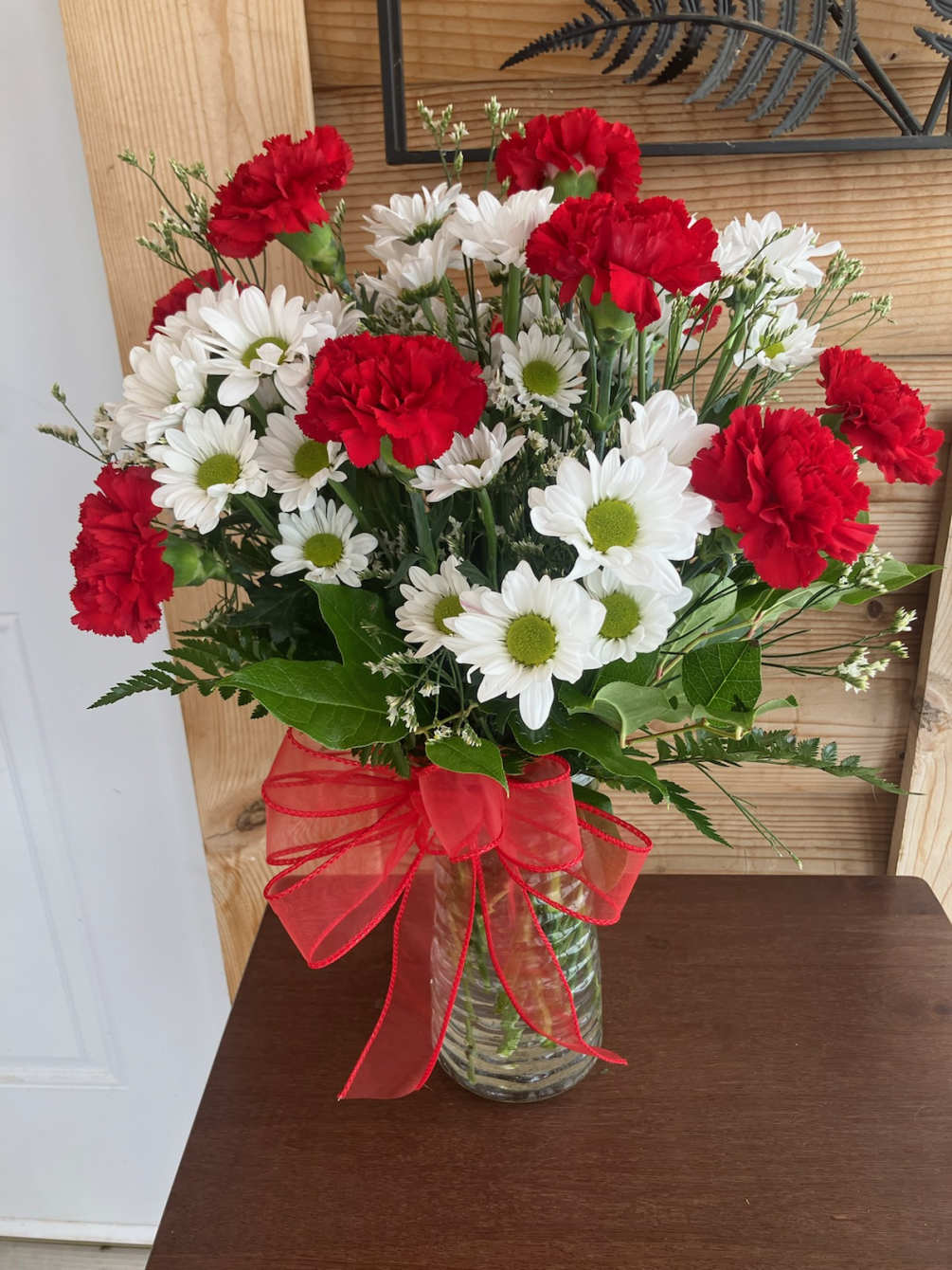 Daisies and red Carnations make this a great arrangement for your sweetheart!