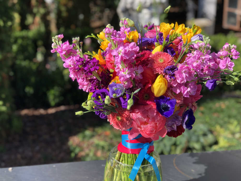 This boldly colorful and bright bouquet is bursting with full and lush