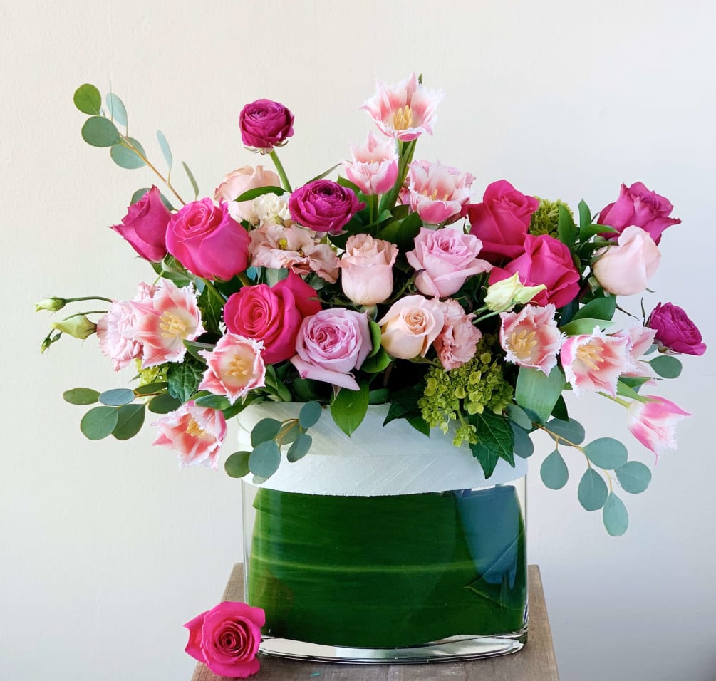 A romantic arrangement of premium spring blooms. This arrangement includes garden roses