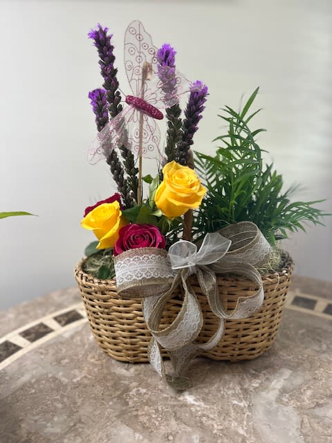 A Designer&#039;s Choice Basket with a plant and a bouquet of fresh