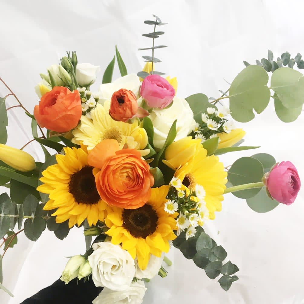 This bright and cheerful custom hand-tied bouquet comes delivered in florist wrapping