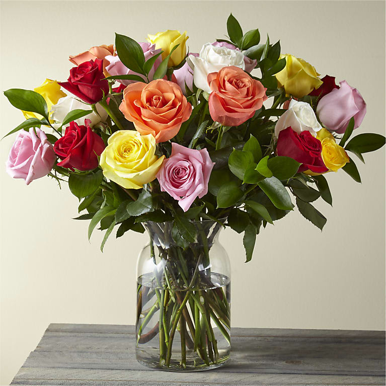 Beautiful bouquet of 24 different colored roses. Glass vase may vary. 
