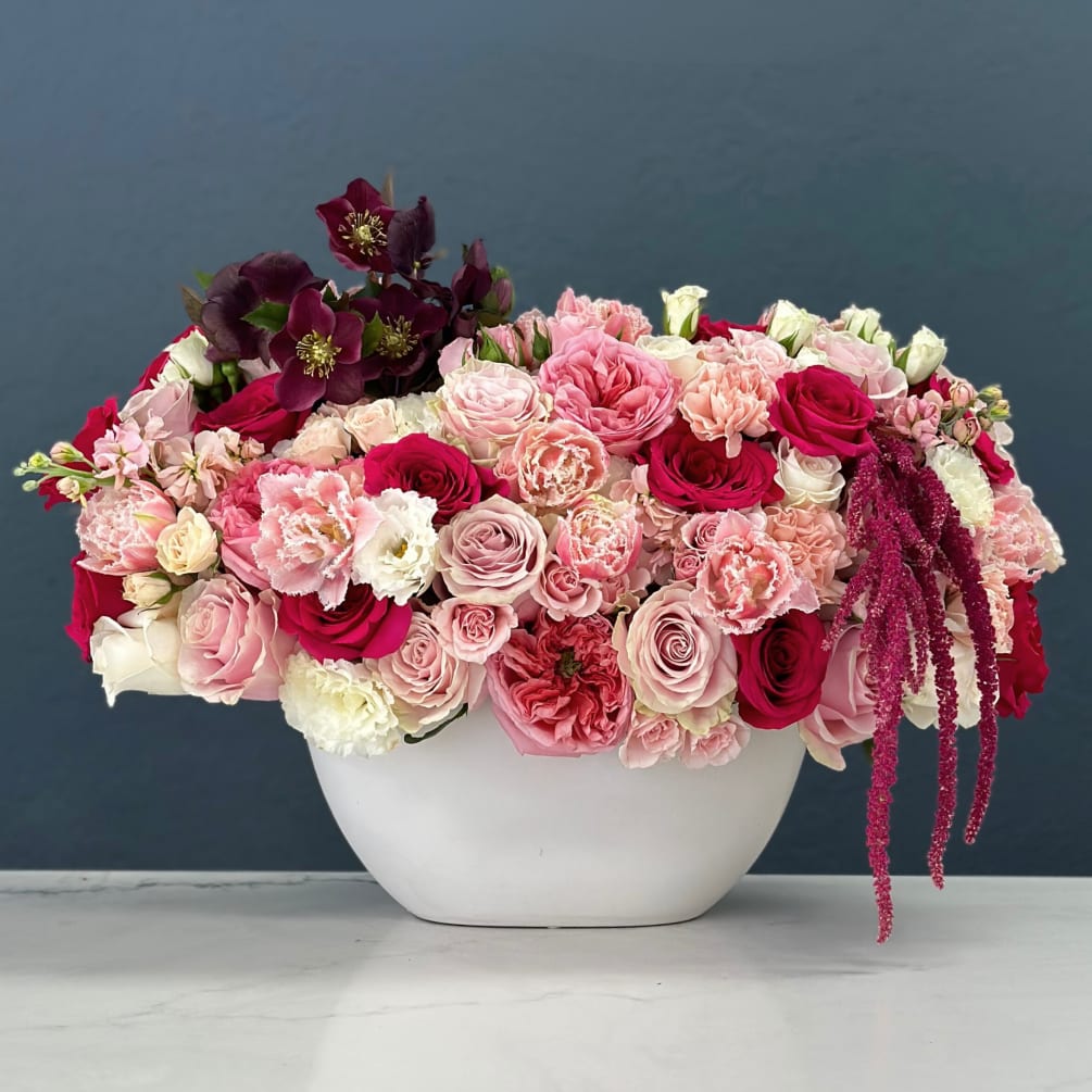 A specialty compact arrangement with warm pink coloration. 