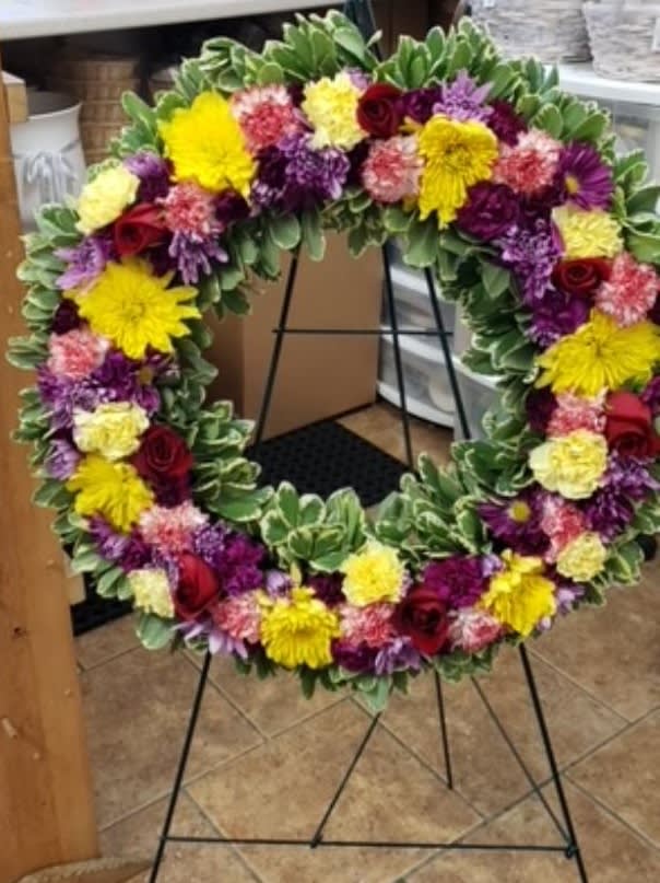 The colorful 18 inch wreath is perfect to send from a group
