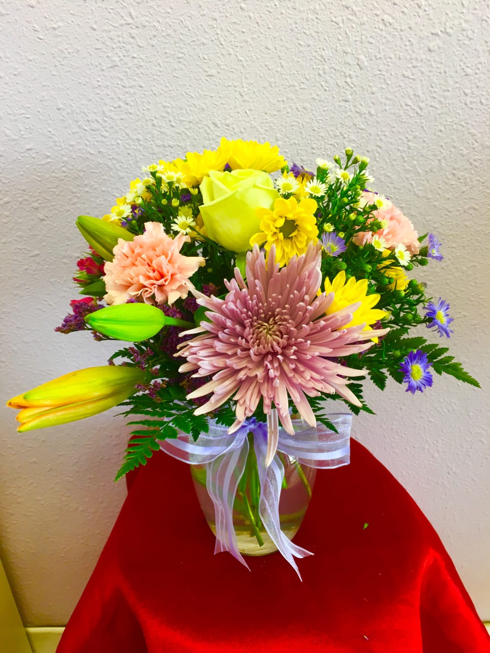 A spring bouquet containing carnations, lilies, spider mums, etc..