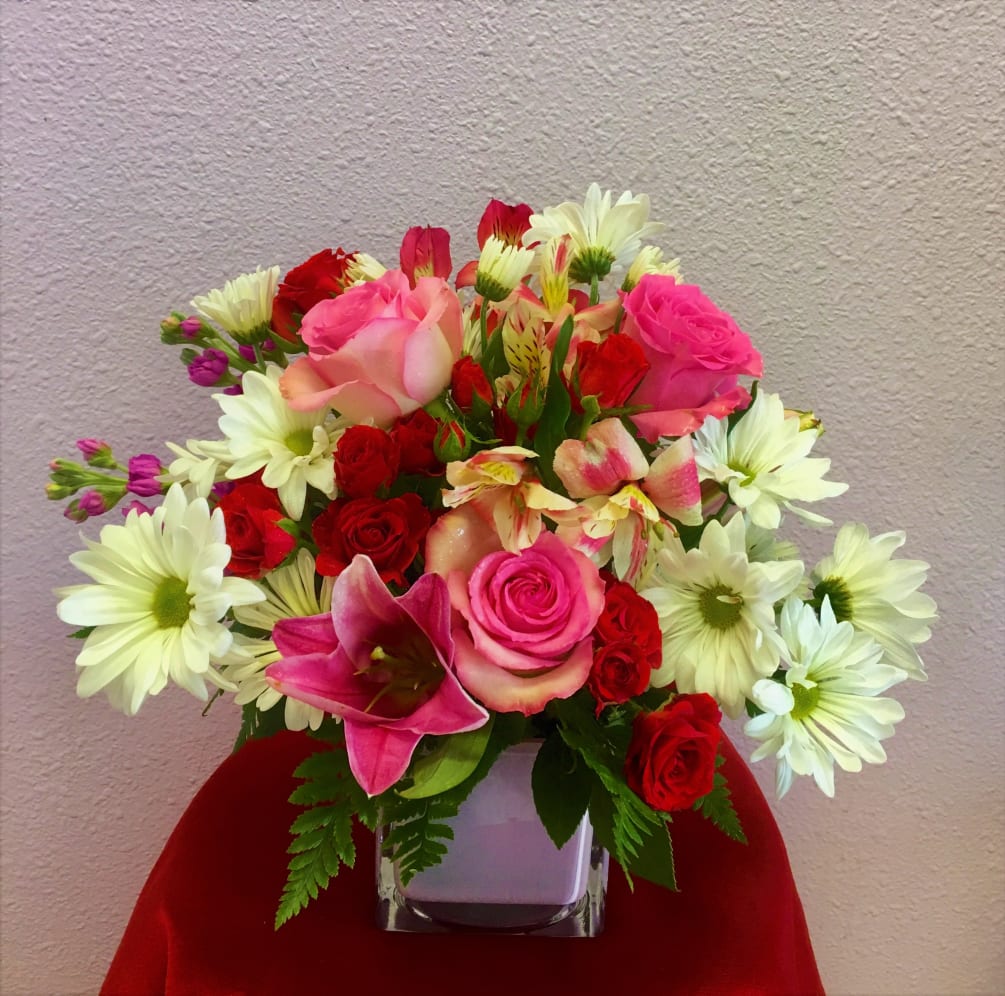 An arrangement suitable for any occasion containing pink roses, pink lilies, daisies