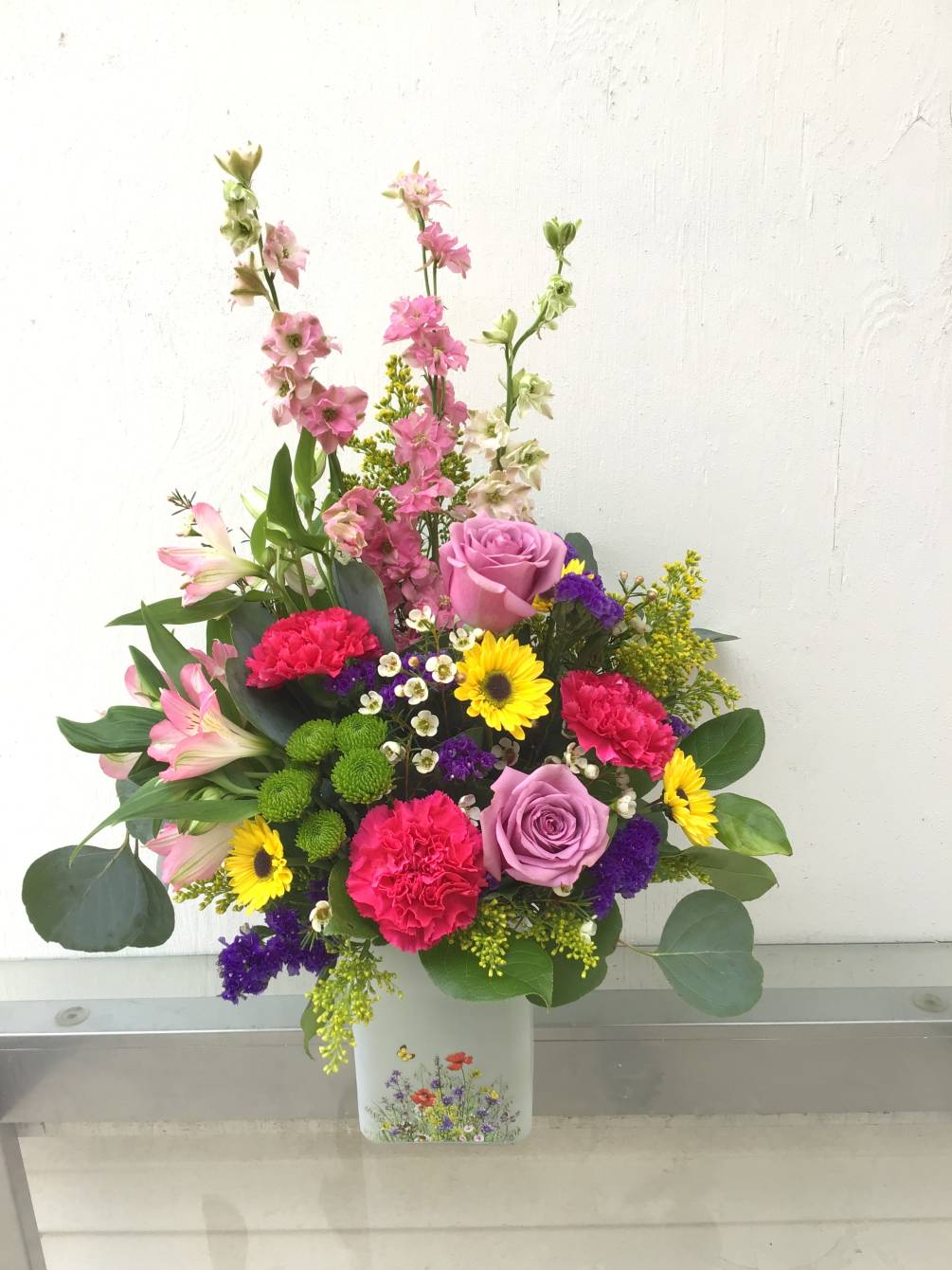 A spring mix of flowers to match a stunning vase for moms.