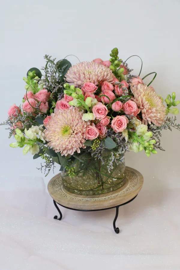 This special arrangement is made with garden roses, chrysanthemums, stock flower and