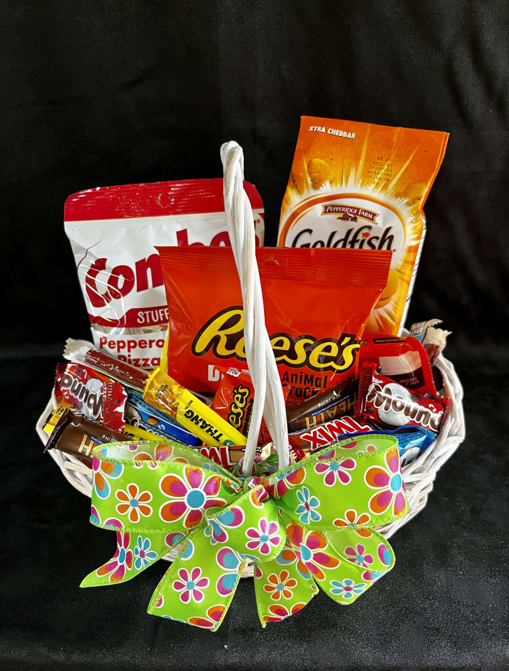 A basket filled with assorted snacks of salty and sweet. Actual product