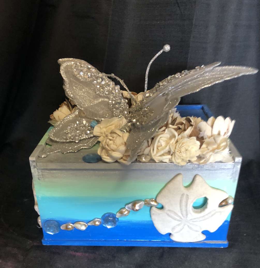 This small to medium sized BLOOMBOX, themed with seashells, sand dollars, rhinestones