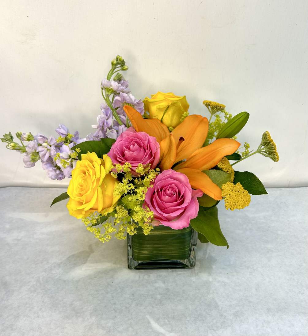Vibrant eye catching mix of bright spring flowers in pinks and yellows