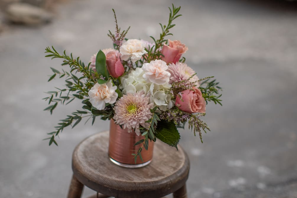 Here luxurious roses in a peachy terracotta tone accompany muted ivory and