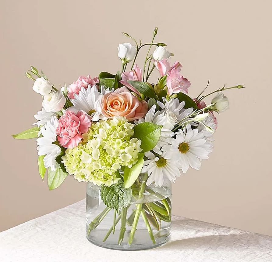 Our charming Flutter by flower arrangement, filled with green hydrangea, white daisies