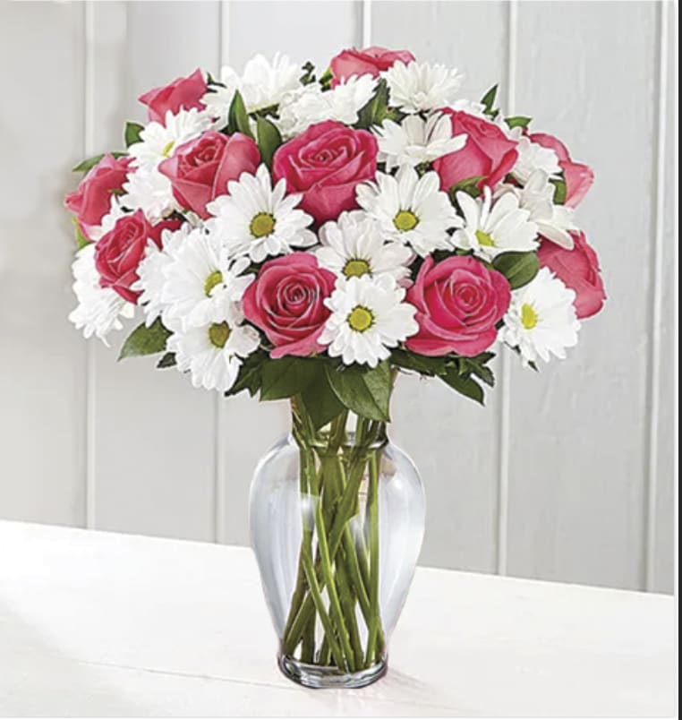 As the title says..pink roses and white daisy arranged in a vase.