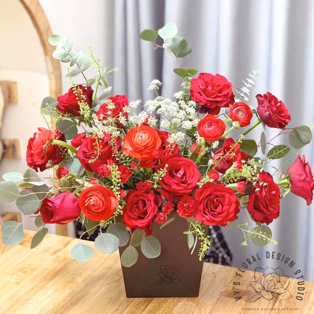 Ruby Slippers, a captivating arrangement of velvety red roses and delicate red