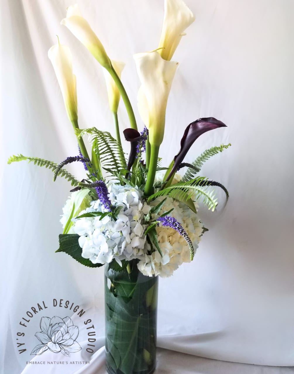  &quot;Dramatic Flair,&quot; a breathtaking flower arrangement that exudes elegance and sophistication.
Luscious