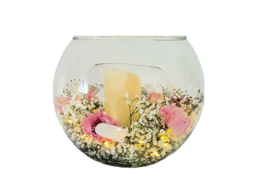 Radiating soft elegance, this fishbowl arrangement glows with the warmth of a