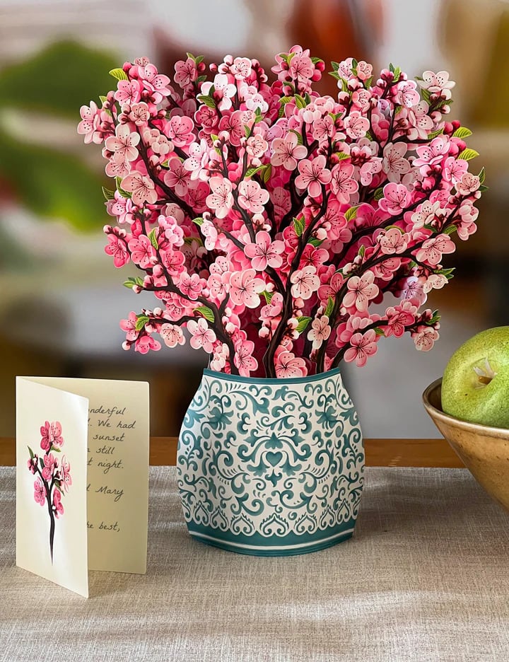 Stunning paper floral bouquet pops open and brings color to any room.