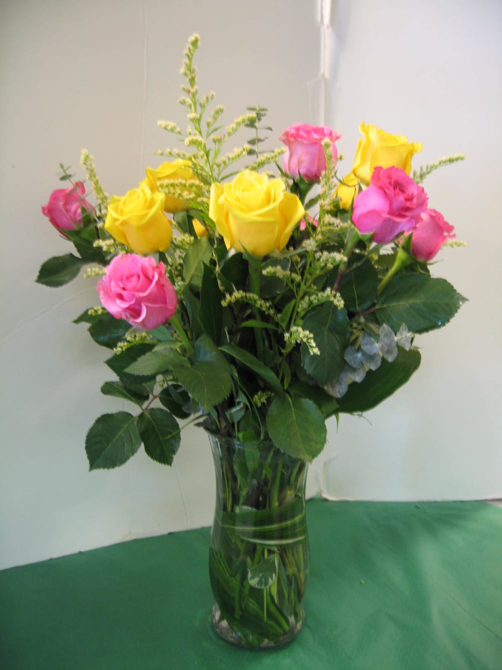 1 Dozen  Assorted  Colored Roses, Fancy Greens
Call for Color Preference