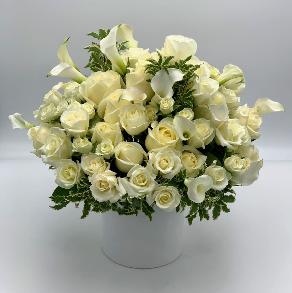 A strikingly beautiful arrangement of Fifty Roses arranged with mini callas and