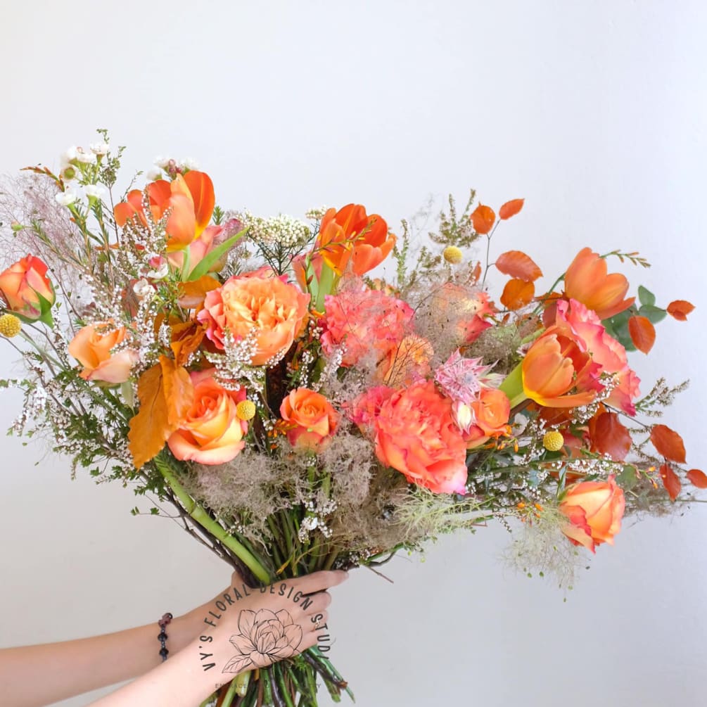 Vibrant and warm, Sunrise Tango bouquet bursts with an array of seasonal