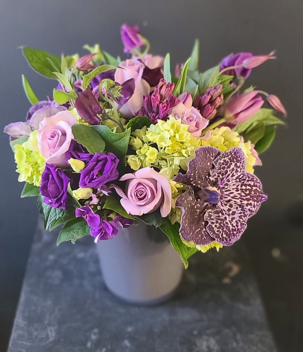 Passionate purple blooms fill this gray modern gray vase. It&#039;s always a