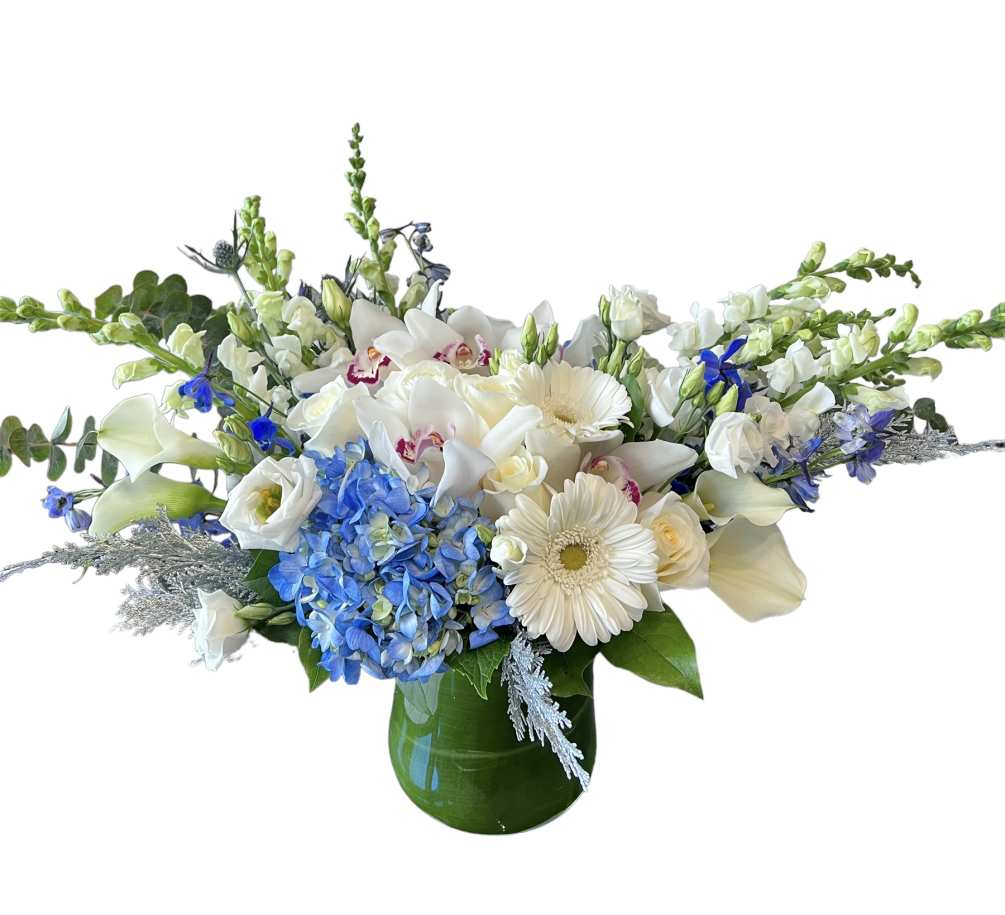 White rose, calla lilies, gerbera daisy, orchid, snap dragons, blue hydrangea, blue