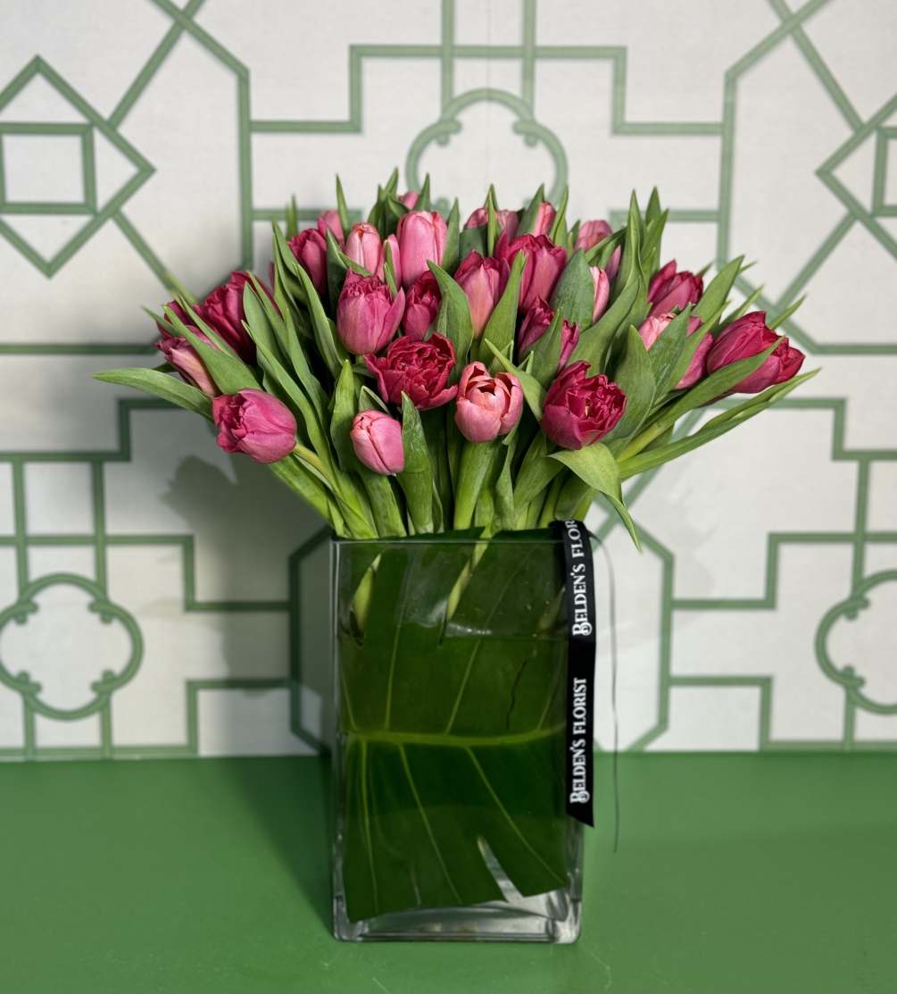 A modern vase filled with 30 colorful tulips to brighten a special