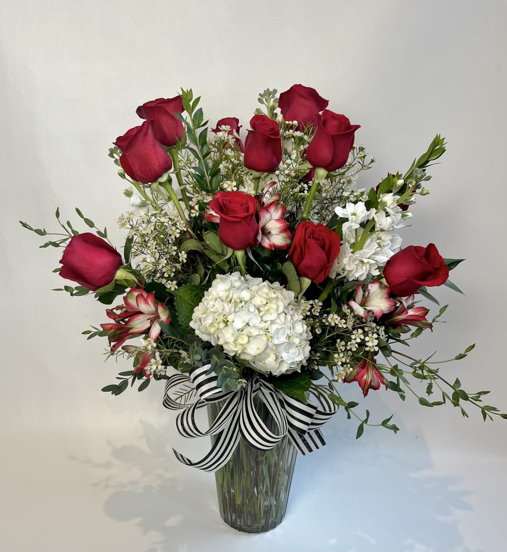 A dozen red roses but upgraded with other flowers. A collar of