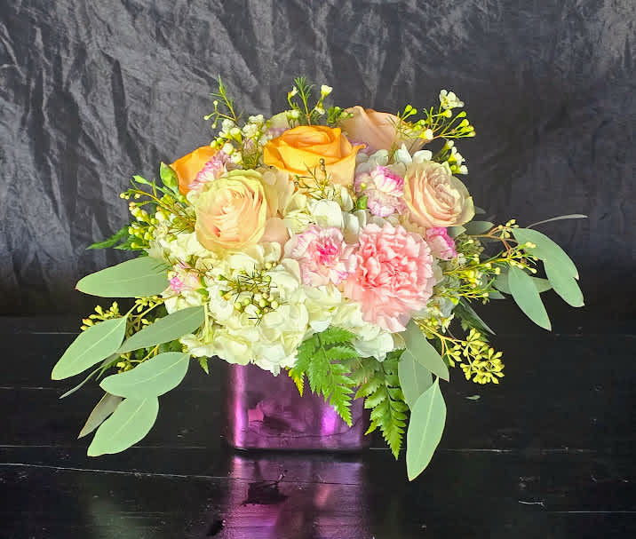 This pretty arrangement features fluffy white hydrangeas with pink roses and carnations!