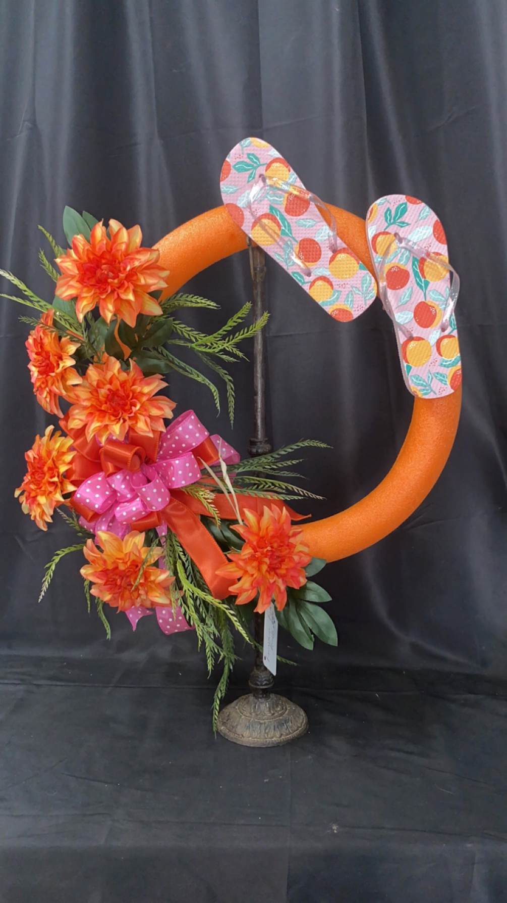 Spring/Summer Wreath made with a pool noodle, flip flops and flowers. 