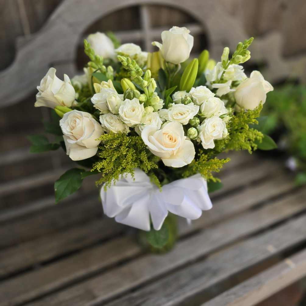 The &quot;Compassionate Rememberance&quot; is a tall all white sympathy arrangement. Featuring All