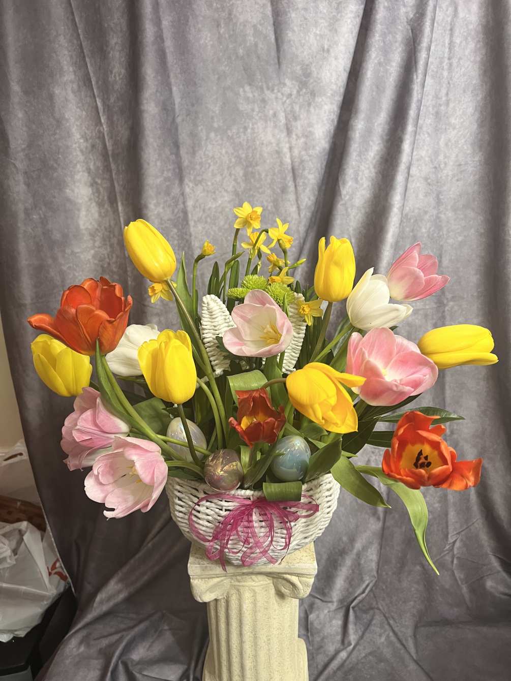 Tulips and spring variety in white bunny ears basket