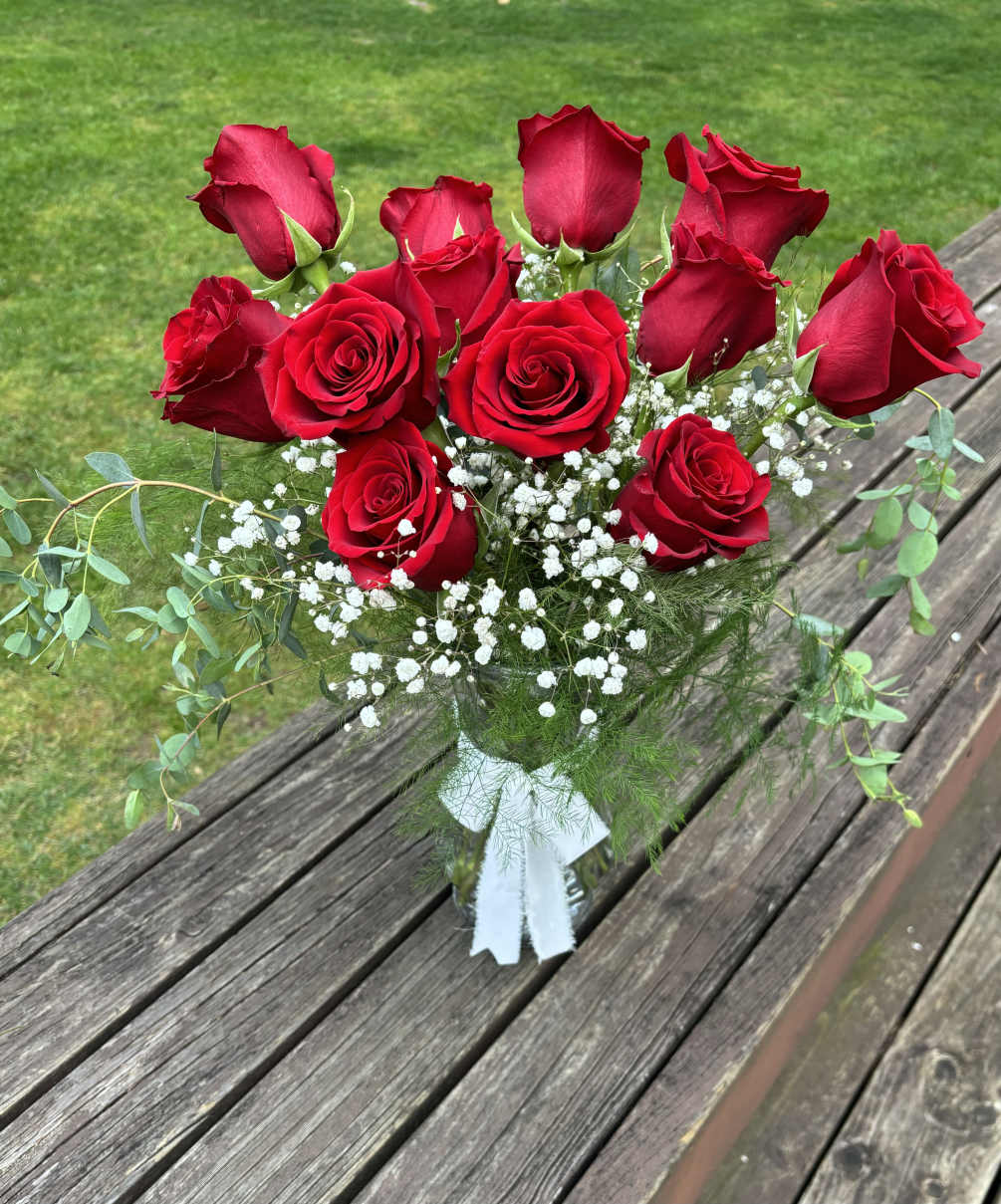Dozen of Red Roses with added greens and filler.

