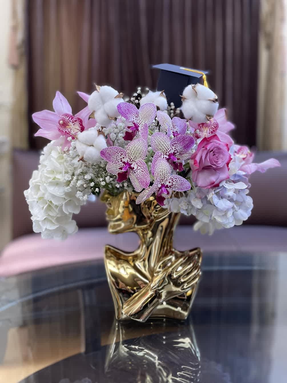 Beautiful head vase flower arrangement to celebrate the graduate.